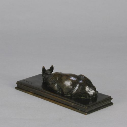 fig 6. A dark brown patinated bronze sculpture depicting a reclining doe resting on a rectangular bronze base signed Barye.