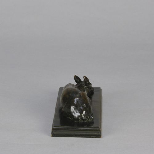 fig 7. A dark brown patinated bronze sculpture depicting a reclining doe resting on a rectangular bronze base signed Barye.