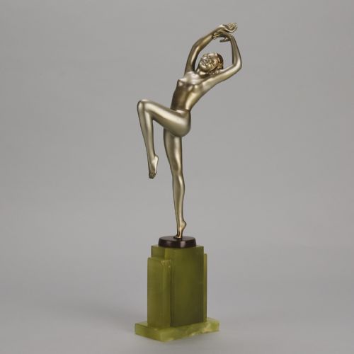 fig 2. An Art Deco cold-painted bronze sculpture of a female dancer balanced on one foot, mounted on a stepped green onyx plinth base.