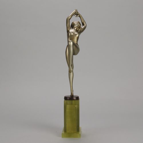 fig 6. An Art Deco cold-painted bronze sculpture of a female dancer balanced on one foot, mounted on a stepped green onyx plinth base.