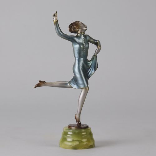 fig 2. An Art Deco cold-painted bronze figurine depicting a female dancer poised on one foot atop a carved green onyx pedestal.
