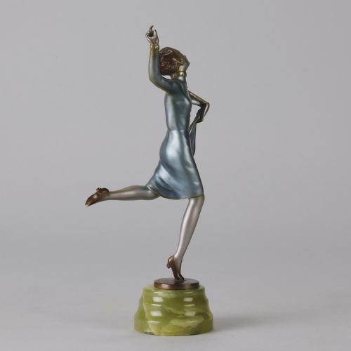 fig 3. An Art Deco cold-painted bronze figurine depicting a female dancer poised on one foot atop a carved green onyx pedestal.