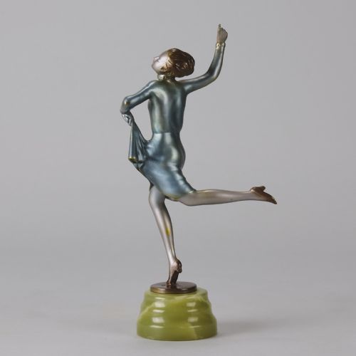 fig 5. An Art Deco cold-painted bronze figurine depicting a female dancer poised on one foot atop a carved green onyx pedestal.
