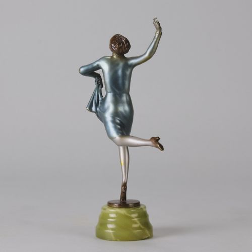 fig 6. An Art Deco cold-painted bronze figurine depicting a female dancer poised on one foot atop a carved green onyx pedestal.