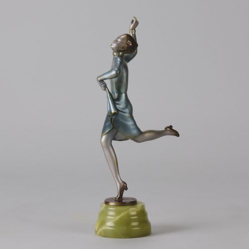 fig 7. An Art Deco cold-painted bronze figurine depicting a female dancer poised on one foot atop a carved green onyx pedestal.