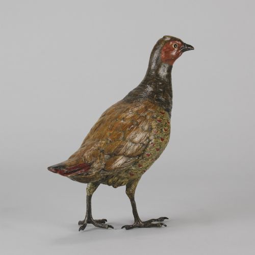 fig 2. A cold-painted bronze sculpture depicting a standing grouse bird with detailed feather texturing in brown, red, and green tones.
