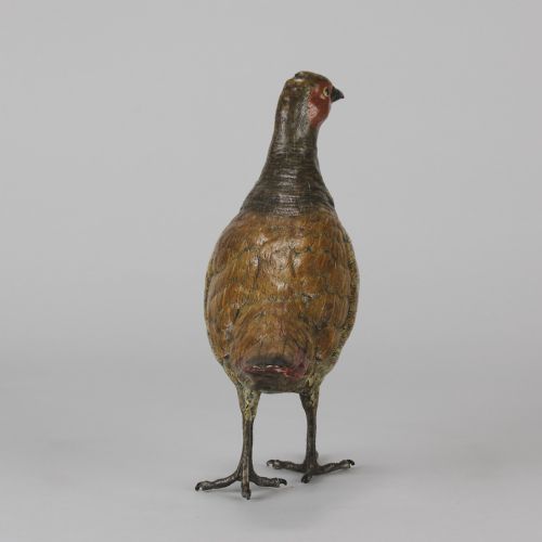 fig 3. A cold-painted bronze sculpture depicting a standing grouse bird with detailed feather texturing in brown, red, and green tones.