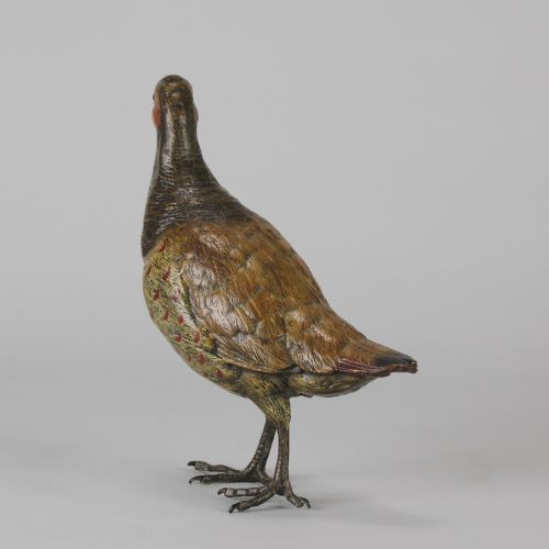 fig 4. A cold-painted bronze sculpture depicting a standing grouse bird with detailed feather texturing in brown, red, and green tones.