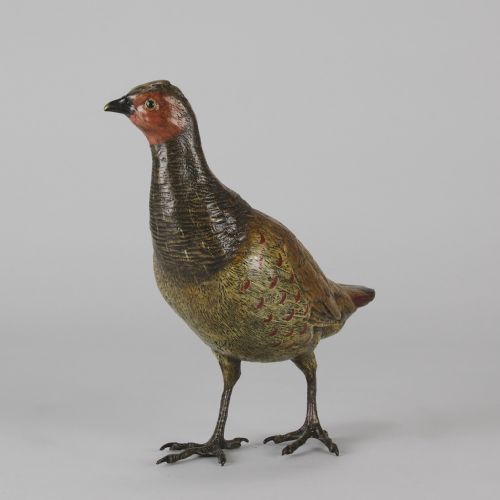 fig 6. A cold-painted bronze sculpture depicting a standing grouse bird with detailed feather texturing in brown, red, and green tones.
