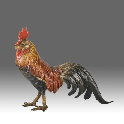 fig 1. A cold-painted bronze figurine depicting a standing cockerel with a red comb and textured feathers in brown, ochre, and dark grey shades.