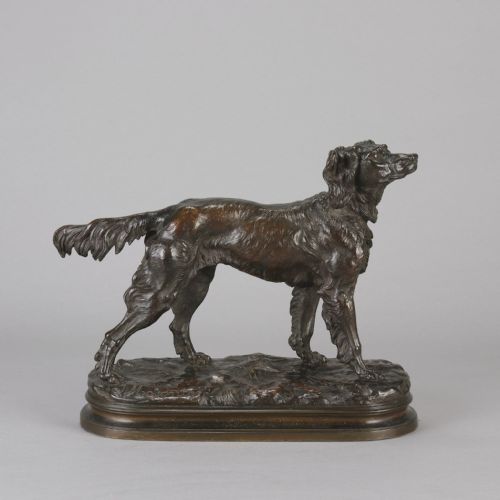fig 1. A dark brown patinated bronze sculpture depicting an Irish Setter standing on an oval naturalistic terrain base with a cast signature.