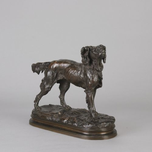 fig 2. A dark brown patinated bronze sculpture depicting an Irish Setter standing on an oval naturalistic terrain base with a cast signature.