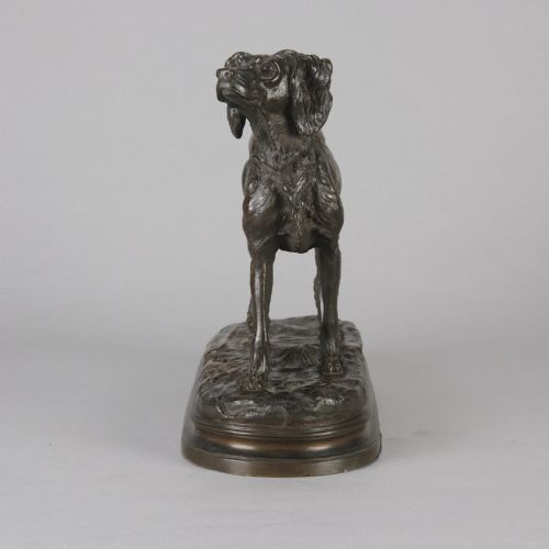 fig 3. A dark brown patinated bronze sculpture depicting an Irish Setter standing on an oval naturalistic terrain base with a cast signature.