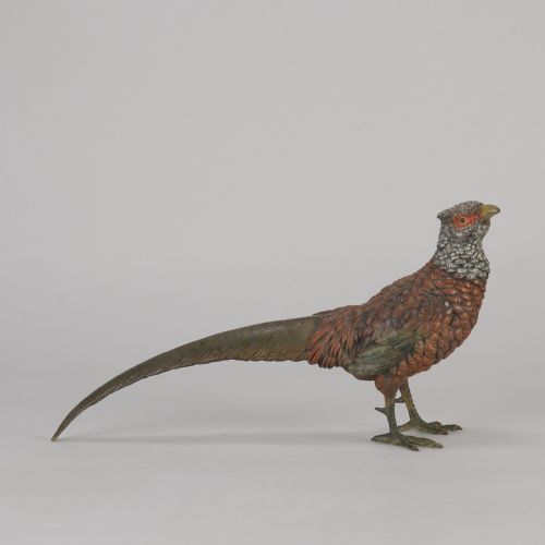 fig 1. An early 20th-century cold-painted bronze sculpture depicting a standing gamebird pheasant with detailed plumage in shades of reddish-brown, grey, and red.