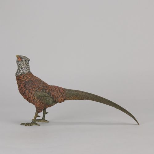 fig 4. An early 20th-century cold-painted bronze sculpture depicting a standing gamebird pheasant with detailed plumage in shades of reddish-brown, grey, and red.