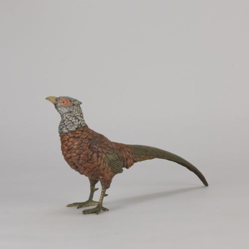 fig 5. An early 20th-century cold-painted bronze sculpture depicting a standing gamebird pheasant with detailed plumage in shades of reddish-brown, grey, and red.