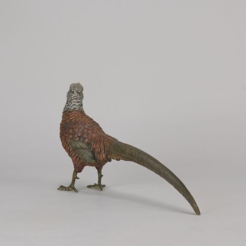 fig 6. An early 20th-century cold-painted bronze sculpture depicting a standing gamebird pheasant with detailed plumage in shades of reddish-brown, grey, and red.