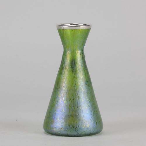 fig 5. A conical iridescent green and blue glass vase decorated with an intricate silver overlay floral design and a silver rim.