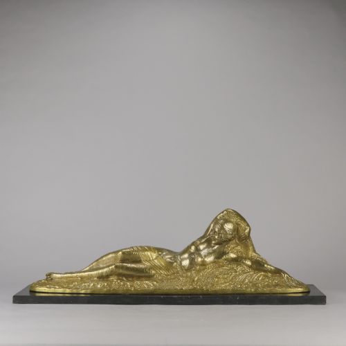 fig 1. An Art Deco gilt bronze sculpture depicting a reclining female figure mounted on a rectangular dark marble base.