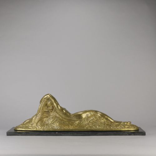 fig 2. An Art Deco gilt bronze sculpture depicting a reclining female figure mounted on a rectangular dark marble base.