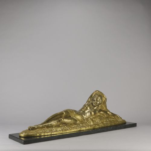fig 3. An Art Deco gilt bronze sculpture depicting a reclining female figure mounted on a rectangular dark marble base.