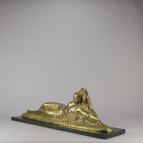 fig 4. An Art Deco gilt bronze sculpture depicting a reclining female figure mounted on a rectangular dark marble base.