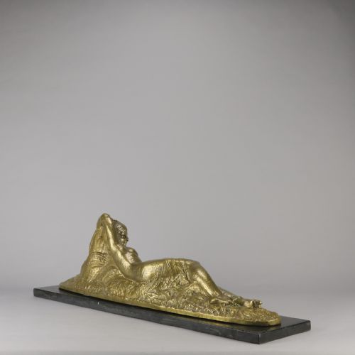 fig 5. An Art Deco gilt bronze sculpture depicting a reclining female figure mounted on a rectangular dark marble base.