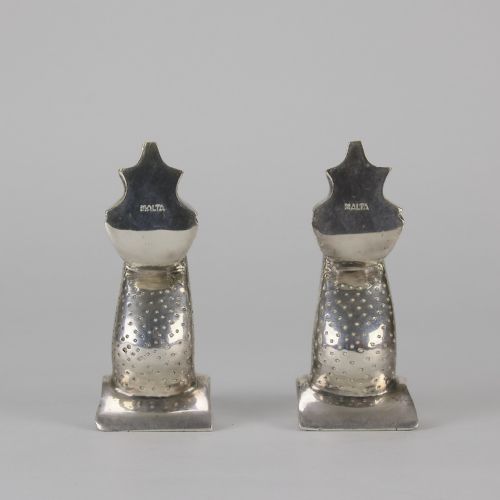 fig 2. A pair of silvered metal bookends sculpted in the shape of upright stylised fish with textured scales and curved tails.