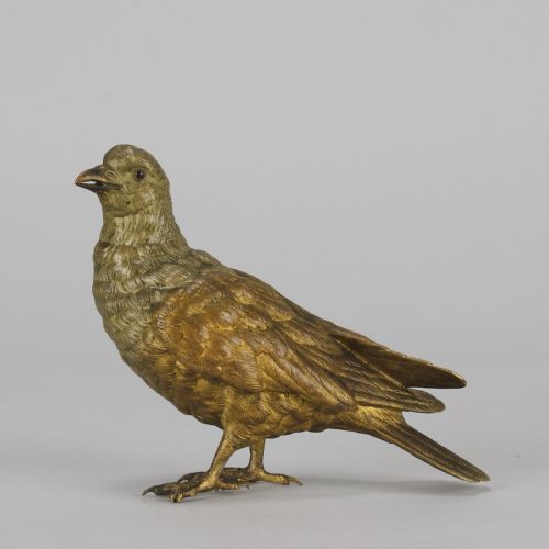 fig 5. A cold-painted bronze figurine depicting a pigeon with textured feathers and a golden finish, standing facing left.