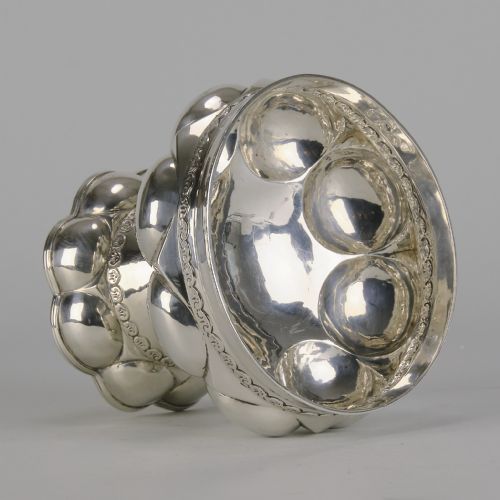 fig 2. An early twentieth-century silver chalice featuring lobed repousse decoration, a wide rim, and a flared pedestal base.