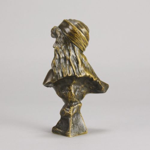 fig 2. A patinated bronze Art Nouveau bust depicting a young woman wearing a headscarf with draped coins, titled Miarka at the base.