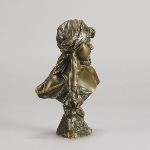 fig 3. A patinated bronze Art Nouveau bust depicting a young woman wearing a headscarf with draped coins, titled Miarka at the base.