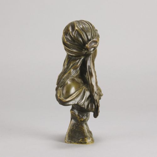 fig 4. A patinated bronze Art Nouveau bust depicting a young woman wearing a headscarf with draped coins, titled Miarka at the base.