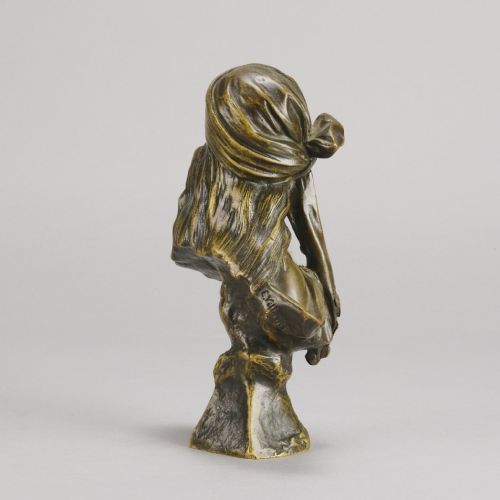 fig 5. A patinated bronze Art Nouveau bust depicting a young woman wearing a headscarf with draped coins, titled Miarka at the base.
