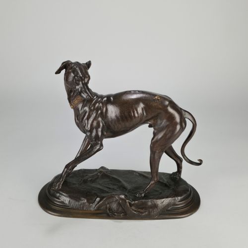 fig 4. A dark brown patinated bronze sculpture depicting a slender greyhound standing on an oval base looking back towards a fly on its hindquarters.