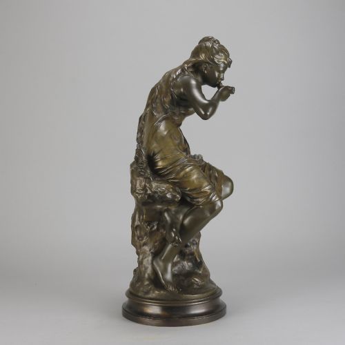 fig 4. A 19th-century dark bronze sculpture of a draped female figure seated on a rocky outcrop, mounted on a circular moulded base.