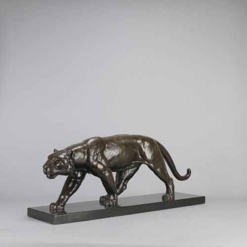 fig 2. An Art Deco dark bronze sculpture of a muscular stalking panther mounted on a thin rectangular dark marble base.