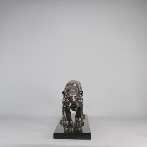 fig 3. An Art Deco dark bronze sculpture of a muscular stalking panther mounted on a thin rectangular dark marble base.