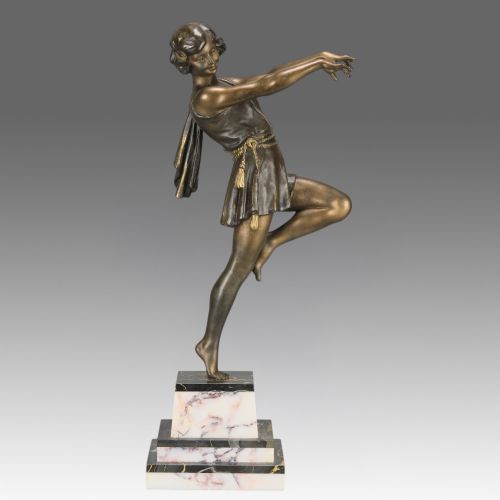 fig 1. An Art Deco bronze figurine of a female dancer captured mid-motion, mounted on a stepped variegated marble base.