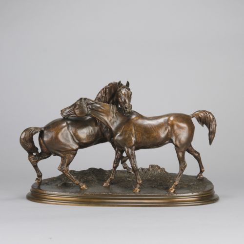 fig 1. A mid-19th-century patinated bronze sculpture depicting two horses nuzzling each other on an oval moulded base.