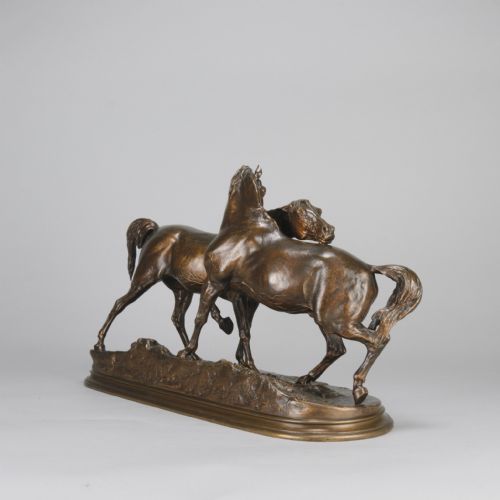 fig 2. A mid-19th-century patinated bronze sculpture depicting two horses nuzzling each other on an oval moulded base.