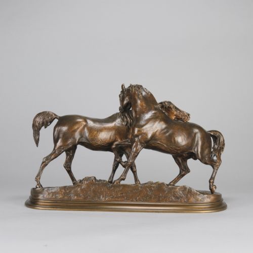 fig 3. A mid-19th-century patinated bronze sculpture depicting two horses nuzzling each other on an oval moulded base.