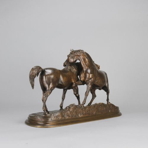 fig 6. A mid-19th-century patinated bronze sculpture depicting two horses nuzzling each other on an oval moulded base.