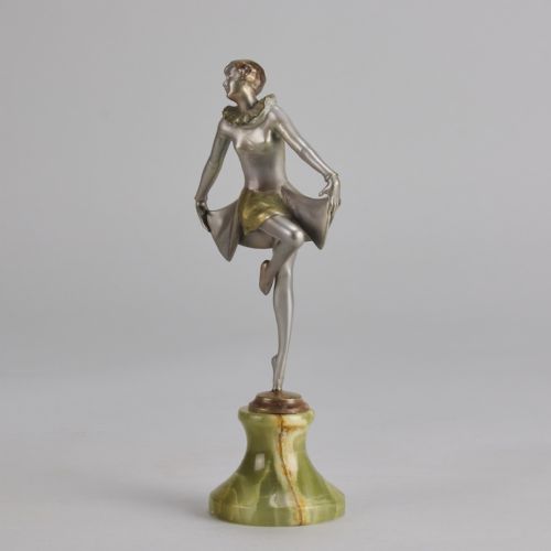 fig 1. An Art Deco cold-painted bronze figurine depicting a female dancer in a curtsy pose mounted on a green onyx base.