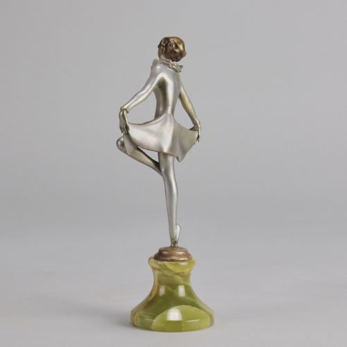 fig 2. An Art Deco cold-painted bronze figurine depicting a female dancer in a curtsy pose mounted on a green onyx base.