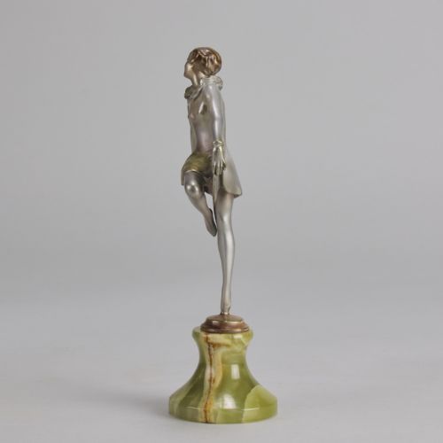 fig 3. An Art Deco cold-painted bronze figurine depicting a female dancer in a curtsy pose mounted on a green onyx base.