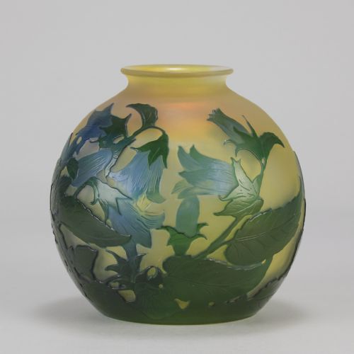 fig 1. A spherical Art Nouveau cameo glass vase featuring green and blue etched bellflowers over a frosted yellow background.