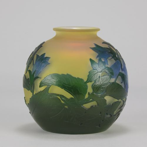 fig 3. A spherical Art Nouveau cameo glass vase featuring green and blue etched bellflowers over a frosted yellow background.