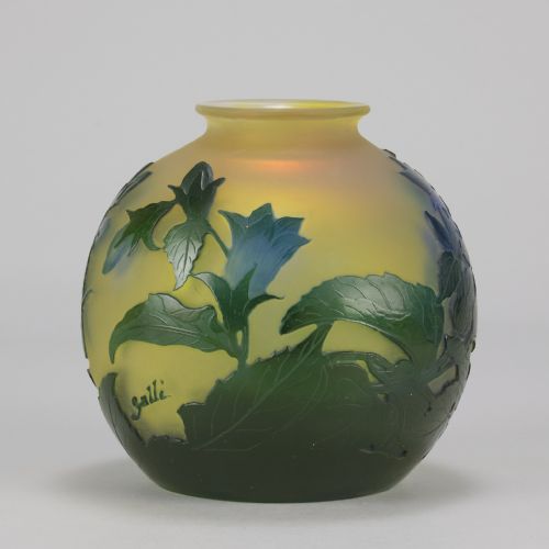 fig 4. A spherical Art Nouveau cameo glass vase featuring green and blue etched bellflowers over a frosted yellow background.