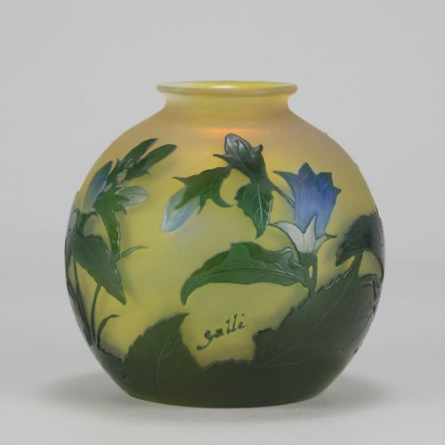 fig 5. A spherical Art Nouveau cameo glass vase featuring green and blue etched bellflowers over a frosted yellow background.